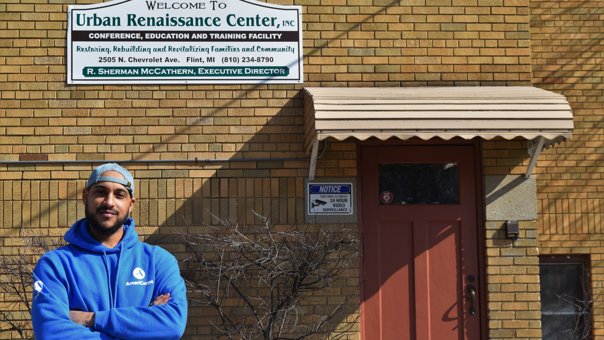 Man in front of brick building